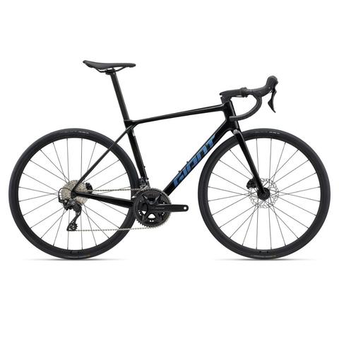 2025 Giant TCR Advanced 2 KOM Road Bike with a sleek black frame and blue accents featuring drop handlebars and disc brakes designed for performance cycling