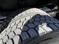 Close-up of a large tire with a detailed tread pattern designed for a 2022 Blue Bird Vision vehicle