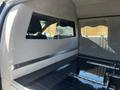 Interior view of a 2013 Lincoln MKT featuring a partition window and a black polished surface with multiple fitted holes