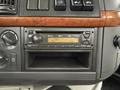 Dashboard of a 2012 Volvo VNL featuring a radio display with Bluetooth and controls along with wooden trim elements