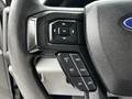 Close-up of the steering wheel controls of a 2017 Ford F-250 including buttons for setting cruise control and navigation functions