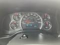 A 2016 Chevrolet Express dashboard showing speedometer fuel gauge and various warning lights with a digital display indicating distance and temperature