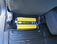 A yellow power inverter labeled 600W installed under the seat of a 2014 Ford F-150