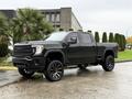 2022 GMC Sierra 3500HD pickup truck with a black exterior oversized wheels and raised suspension