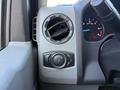 Close-up of the dashboard controls in a 2021 Ford Econoline featuring an air vent and a dial for adjusting headlights