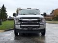 A 2021 Ford F-550 truck facing forward with a chrome grille and large headlights