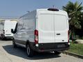 A white 2022 Ford Transit van seen from the rear with a smooth finish and standard taillights