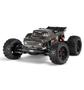 A remote-controlled 1/10 scale brushless stunt truck with large knobby tires and a detailed body design featuring a gray finish and red accents