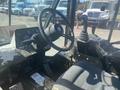 Close-up of the interior of a 2010 Trackless MT6 showing the steering wheel gear shift lever and dashboard with various gauges and buttons