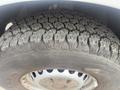 Close-up of a rugged tire from a 2009 Dodge Sprinter Van showing deep treads designed for all-terrain grip and stability