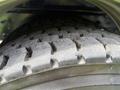 Close-up of a treaded tire from a 2014 International 7500 showing pronounced grooves and patterns on the rubber surface