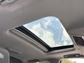 The interior of a 2017 Chevrolet Silverado 1500 featuring a sunroof with visible sky and clouds above