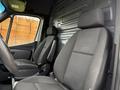 Interior of a 2019 Mercedes-Benz Sprinter featuring two front seats side by side in black fabric with a minimalist design