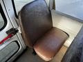 A brown vinyl bus seat inside a 2005 Blue Bird 48 passenger bus