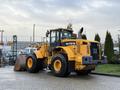 A yellow Hyundai HL770-7A wheel loader with large tires and a front bucket is parked, showcasing its robust construction equipment design