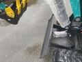A 2024 AGT Industrial MH12R Mini Excavator showcasing a black metal blade attached to the front with visible hydraulic connections and textured rubber tracks