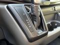 A 2023 Ford Transit gear shifter with a leather-wrapped knob displaying the settings P R N D M