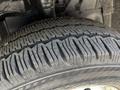Close-up of a treaded tire from a 2023 Ford Transit showing deep grooves and ridges designed for improved traction and stability
