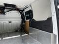 Interior of a 2016 Ford Transit Connect showing the cargo area with metal flooring and side walls without any visible shelves or storage units