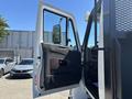 A 2018 International DuraStar truck with the driver's door open showcasing the interior and dashboard