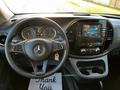 Interior view of a 2022 Mercedes-Benz Metris featuring a steering wheel with controls a digital dashboard and a central entertainment display with climate control buttons