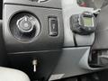 Interior dashboard controls of a 2016 Ford F-550 including switches for lights and a digital display device mounted on the panel