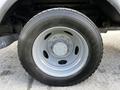 Close-up of a 2008 Ford F-550 tire showcasing the tread pattern and silver rim with multiple lug nut holes