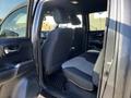 Interior view of a 2021 Toyota Tacoma showcasing the rear seating area with black and gray fabric upholstery and a black floor mat