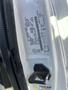 A white 2008 Ford Econoline with a close-up view of the door jam and vehicle information sticker visible