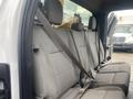 Interior view of a 2017 Ford F-550 featuring a gray fabric bench seat with seat belts and headrests