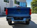 A blue 2021 Chevrolet Colorado pickup truck viewed from the rear showcasing the brand name and model on the tailgate