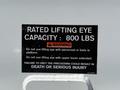 A black warning label on a white surface indicating the rated lifting eye capacity is 800 lbs with safety instructions regarding personnel and equipment