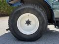 Close-up of a large tire from a 2018 New Holland Boomer 45 tractor featuring a white rim and rugged tread pattern