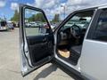 A 2006 Land Rover LR3 with an open driver's side door revealing the interior and dashboard