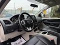 Interior view of a 2017 Dodge Grand Caravan featuring a black leather steering wheel and dashboard with gauges and controls