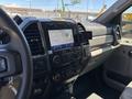 Interior dashboard of a 2020 Ford F-350 Super Duty featuring digital display controls air conditioning knobs and a phone holder