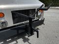 A 2008 Morgan Olson Workhorse with a metal frame and multiple attachments mounted on the front, designed for utility use
