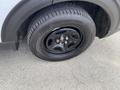A close-up of a black wheel and tire from a 2021 Ford Explorer showing the tread pattern and rim design