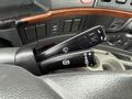 Close-up of the control stalks inside a 2012 Volvo VNL featuring knobs for windshield wipers and headlights with various switches and buttons in the background