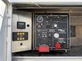 A control panel with various switches and dials for a 2024 Ford F-550 featuring a DC welder charger air compressor and generator controls