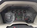 Dashboard of a 2008 Ford F-450 SD showing speedometer, tachometer, and various warning lights along with a digital display indicating mileage and other metrics