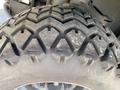 Close-up of a rugged tire from a 2018 Kubota RTV-X 1100 C featuring a deep tread pattern designed for off-road traction