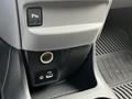 Dashboard console of a 2020 Nissan NV200 featuring a parking assist button USB port and auxiliary input