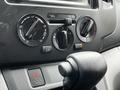 Control panel of a 2020 Nissan NV200 featuring temperature dials and air conditioning settings