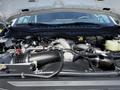 Close-up of a 2023 Ford F-550 engine showing various components including the intake and cooling systems