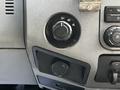 Control panel of a 2016 Ford F-550 featuring a rotary dial for drive modes and various switches and knobs for vehicle settings