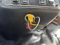 A close-up view of the ignition switch and key of a 2018 Chevrolet Express featuring a yellow key tag and a red button labeled "FIRE"