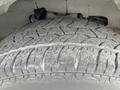 Close-up of a worn tire from a 2013 Chevrolet Express showing detailed tread pattern and signs of usage