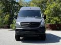 Front view of a 2017 Mercedes-Benz Sprinter van with a gray exterior and prominent Mercedes logo on the grille