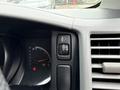 Dashboard controls of a 2009 Toyota Hiace featuring the gear shift indicator and a button for interior lighting
